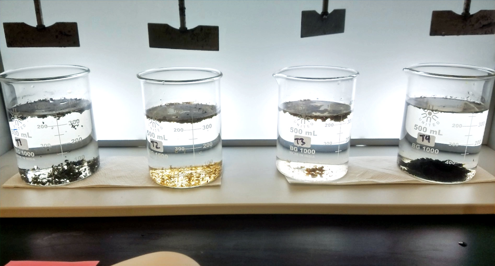 Laboratory jar test showing different CPAM dosage levels on Permian Basin sludge